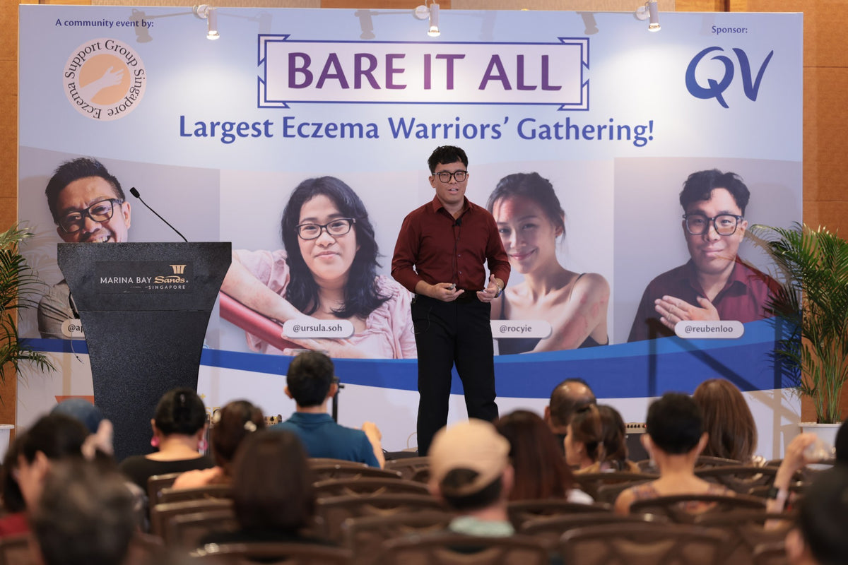 Reuben speaking on stage at Bare It All, Singapore's largest eczema gathering, April 2024