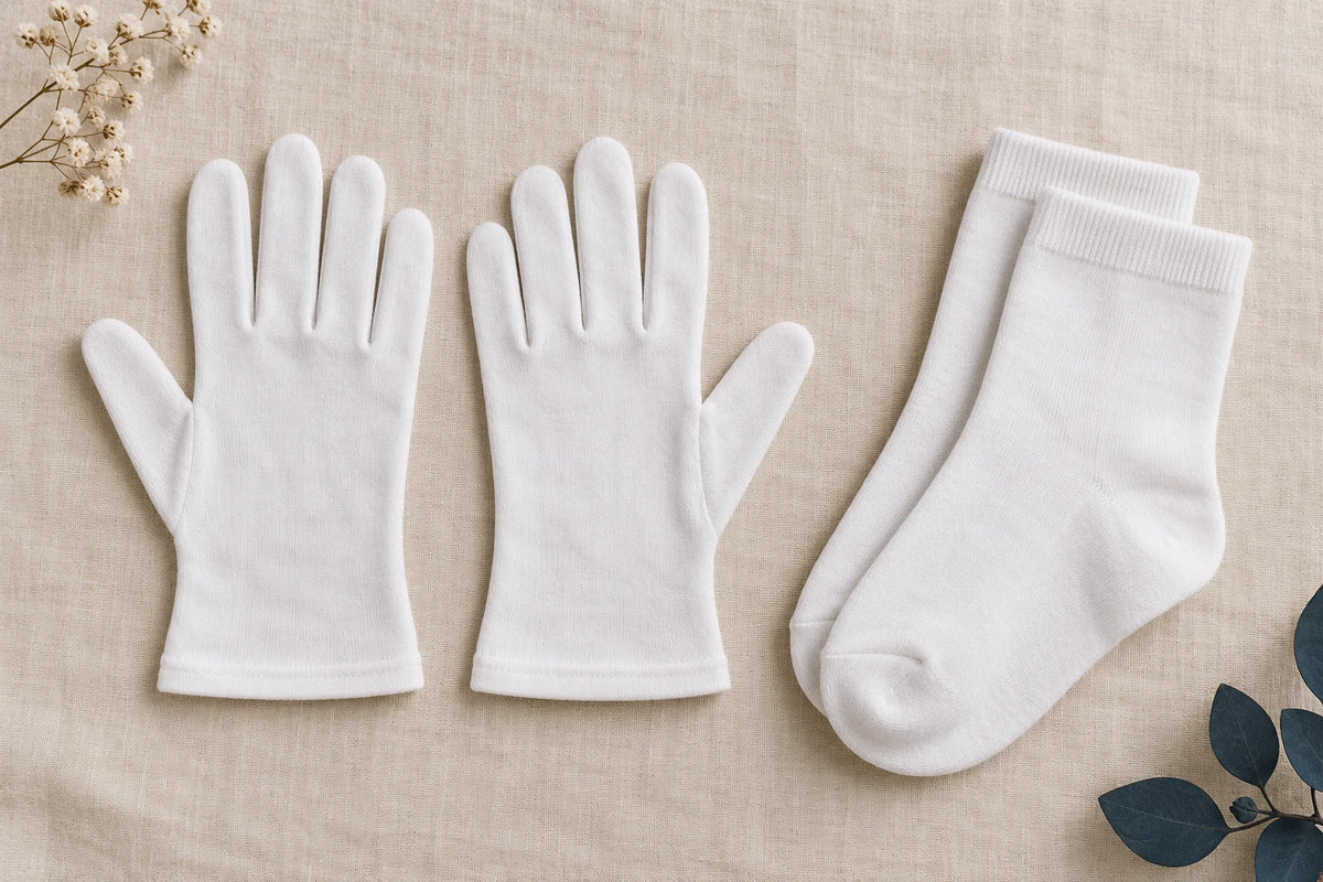 Cotton gloves beside a separate pair of ordinary cotton socks